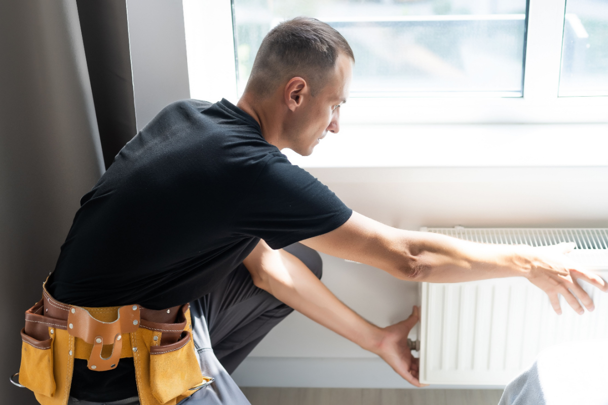 Technician installing and tuning up a new ac and heating unit