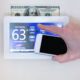 smart thermostat with $100 bill behind it to show the energy savings earned